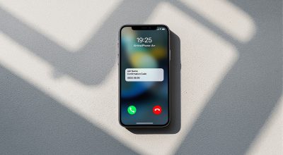 Apple iPhone 16 Pro resting face-up on a smooth warm grey concrete surface