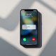 Apple iPhone 16 Pro resting face-up on a smooth warm grey concrete surface