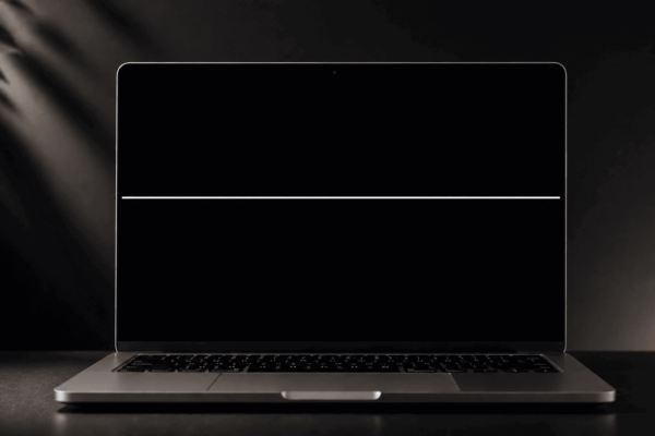 Minimalist laptop with soft lighting with a white line on the Mac screen