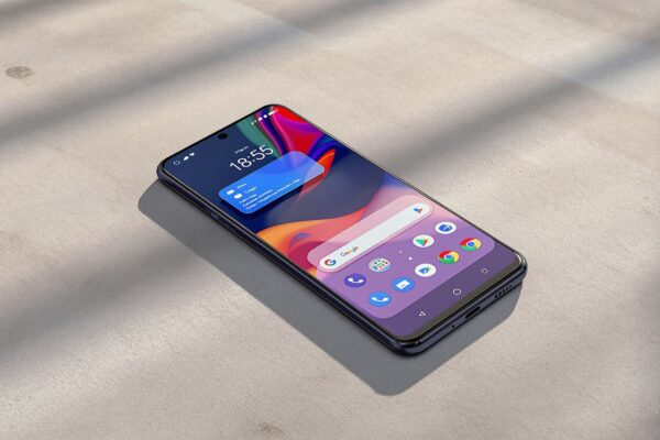 Google Pixel 10 Pro lying flat on a warm grey concrete surface, screen showing Android 17 home screen with a floating app bubble overlay visible, cinematic side lighting from the left with soft long directional shadows, no hands, no people, no text, sharp focus, photorealistic, 16:9